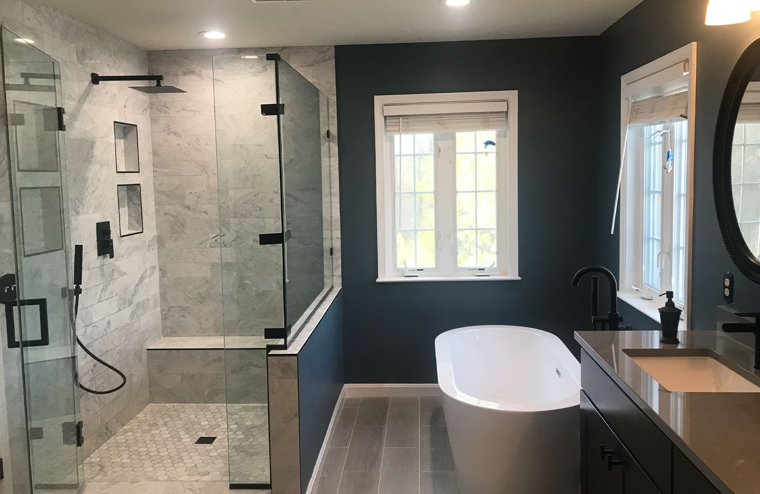Spa bathroom renovation with freestanding tub and tile shower