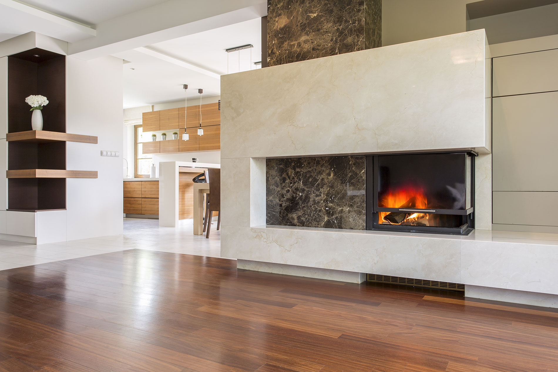 Large lounge space with stone fireplace surround