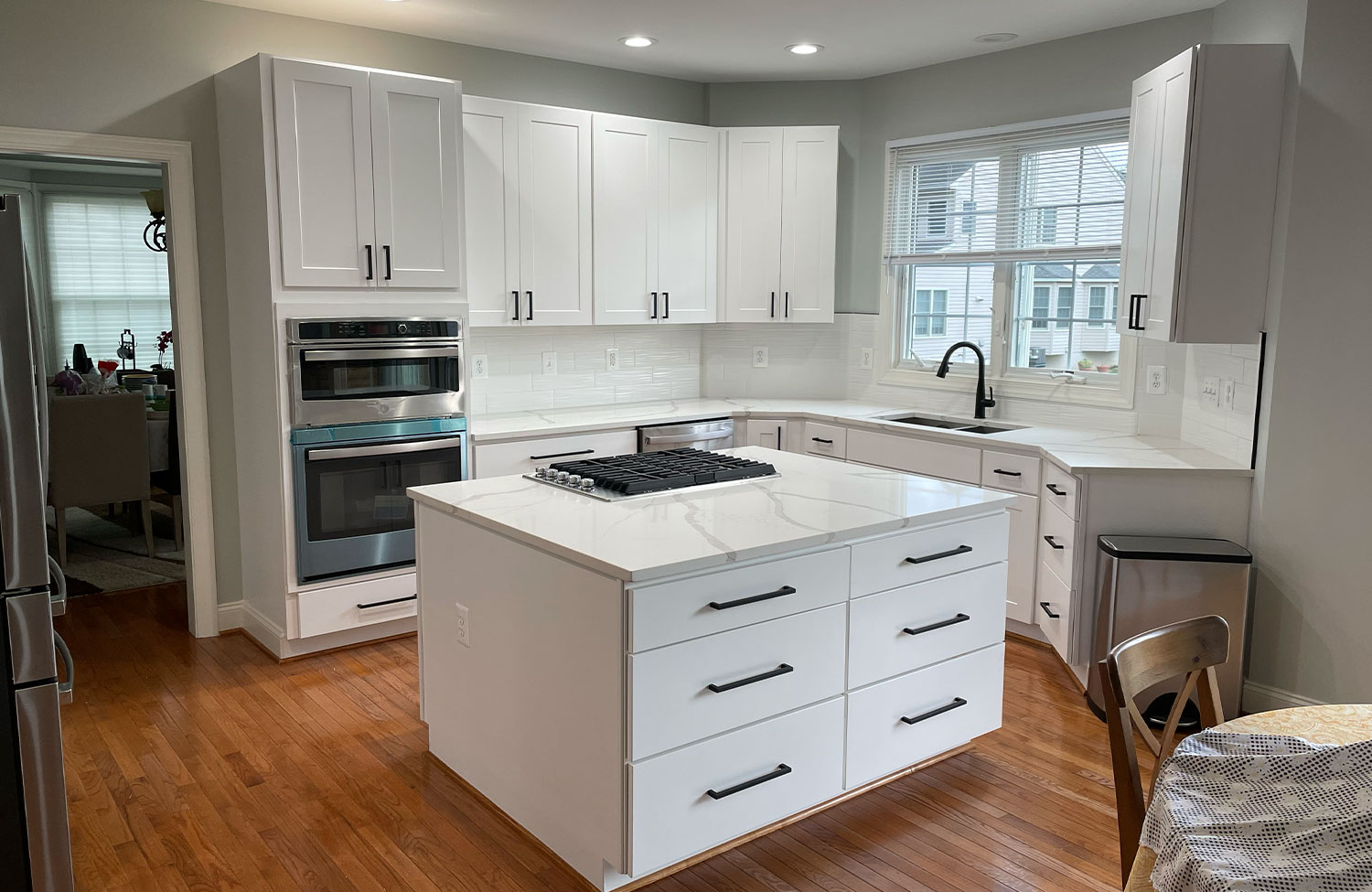Kitchen renovation with quartz island and wall ovens