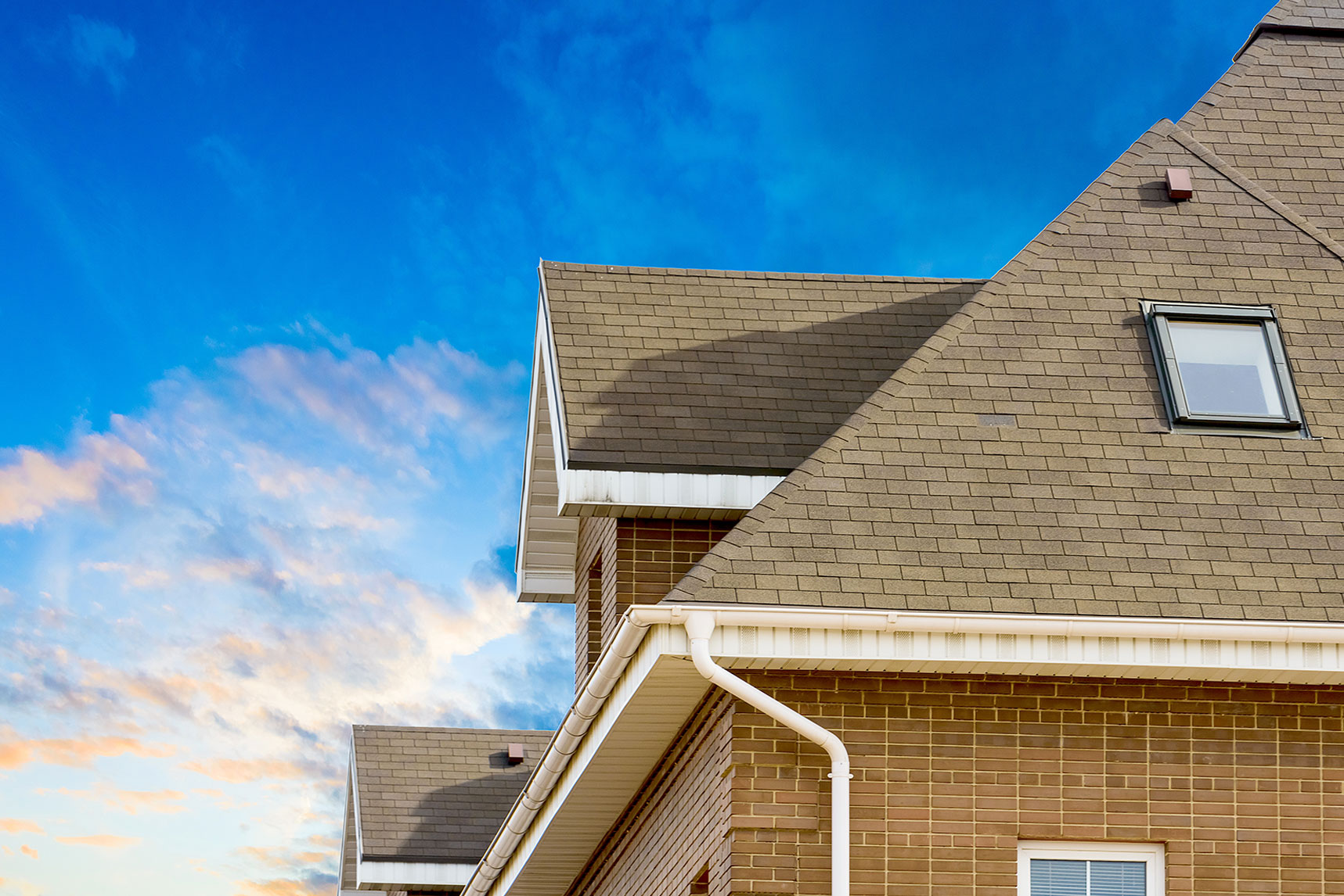 Roof and cedar shake gable detail against blue sky