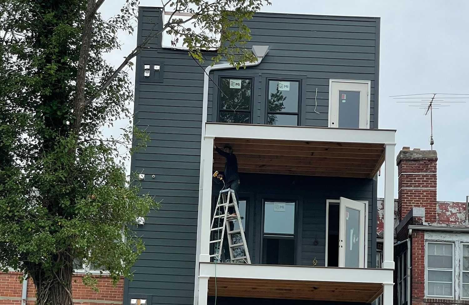 Modern rowhouse new build with dark siding under construction
